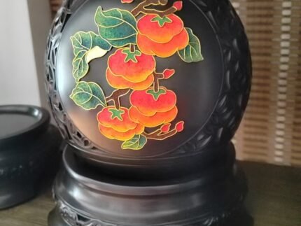 Black pottery decorative vase with red persimmon motif and carved base