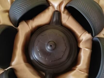 Black pottery gongfu tea set with teapot and textured cups in a gift box