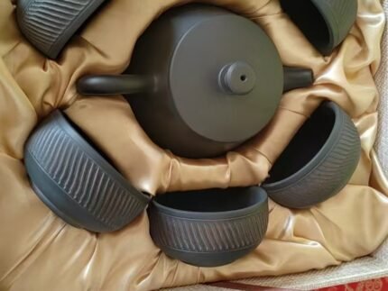 Handmade black pottery Gongfu tea set with teapot and six textured ceramic cups for Zen tea room decor